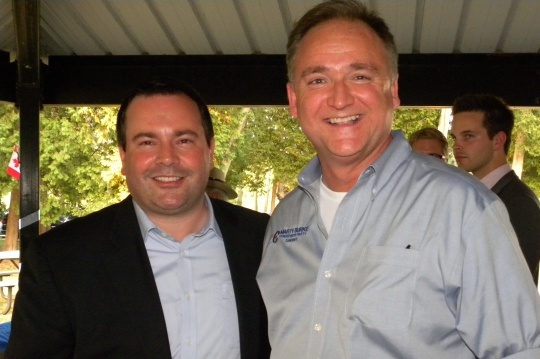 Kenney poses with federal Conservative candidate Marty Burke at a Conservative rally BBQ. 