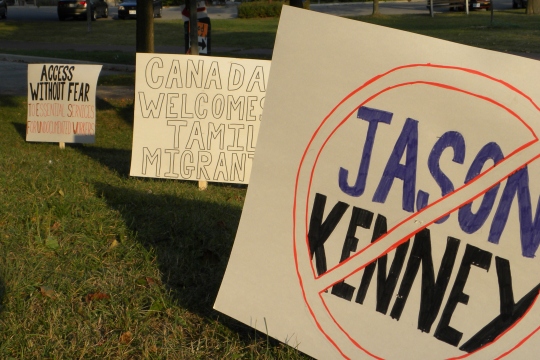 Signs were posted by immigration activists at Riverside Park to protest Kenneys appearance.